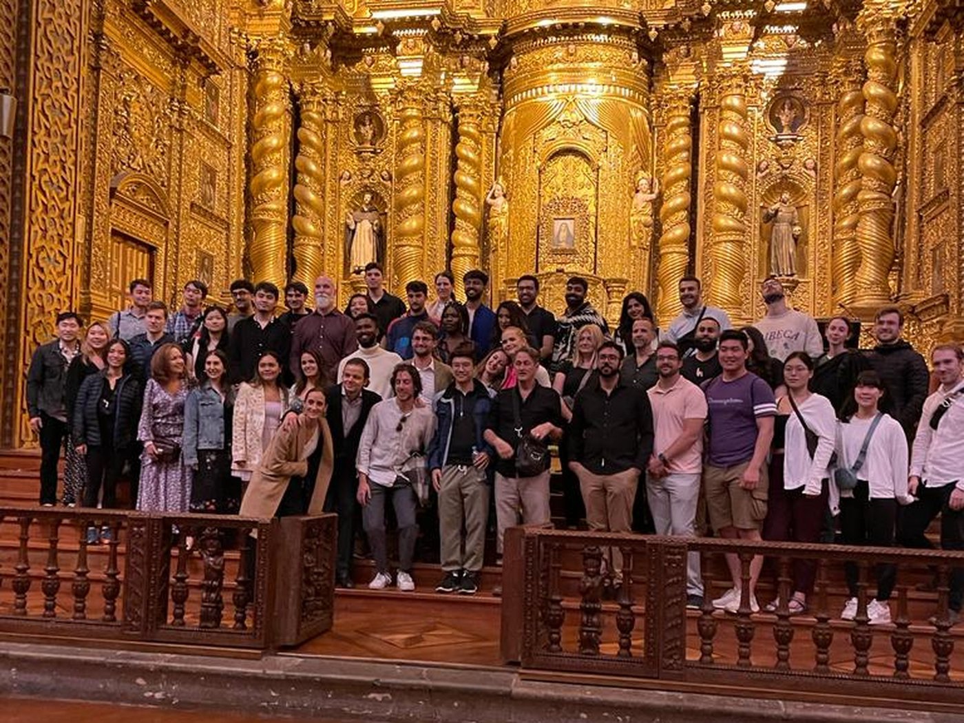 The full group inside a gilded church in Quito