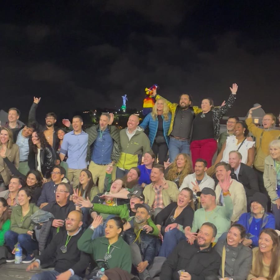 The full group of guests together at night